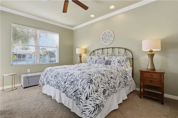 a bed sitting in a bedroom next to a lamp