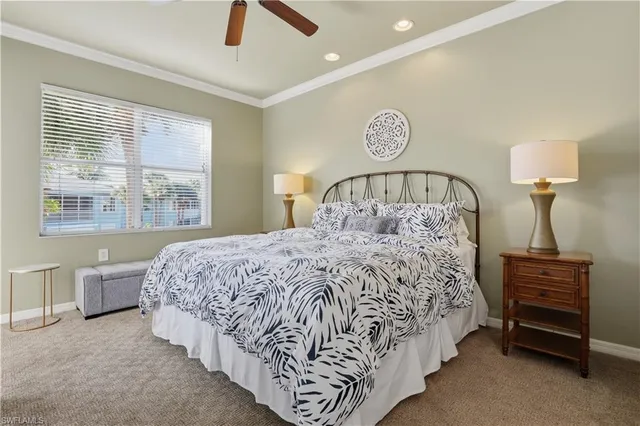 a bed sitting in a bedroom next to a lamp