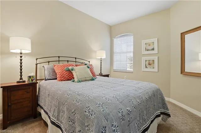 a bedroom with a bed and a night stand