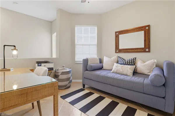 a living room with furniture and a lamp