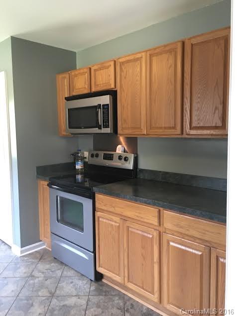 4594 Wylies Mill Road, Unit 1 Edgemoor, SC 29712 - Photo 11 of 11 a kitchen with granite countertop a sink stainless steel appliances and cabinets