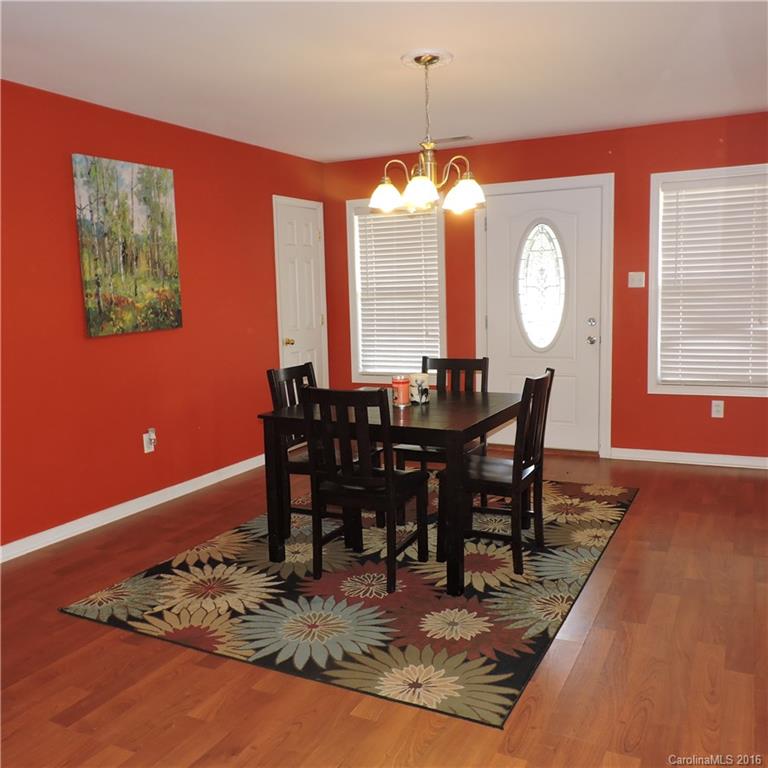 4594 Wylies Mill Road, Unit 1 Edgemoor, SC 29712 - Photo 4 of 11 a dining room with furniture a rug and a large window