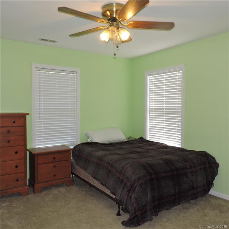 4594 Wylies Mill Road, Unit 1 Edgemoor, SC 29712 - Photo 6 of 11 a bedroom with a bed and a chandelier