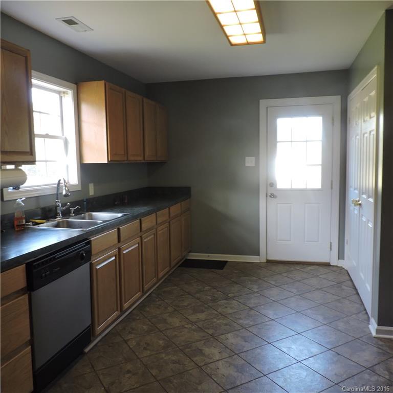 4594 Wylies Mill Road, Unit 1 Edgemoor, SC 29712 - Photo 8 of 11 a kitchen with a sink cabinets and window