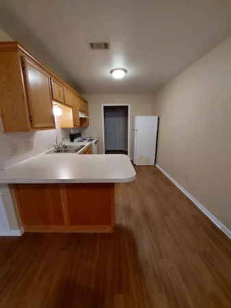 a living room with hard wood floors and a wooden floors