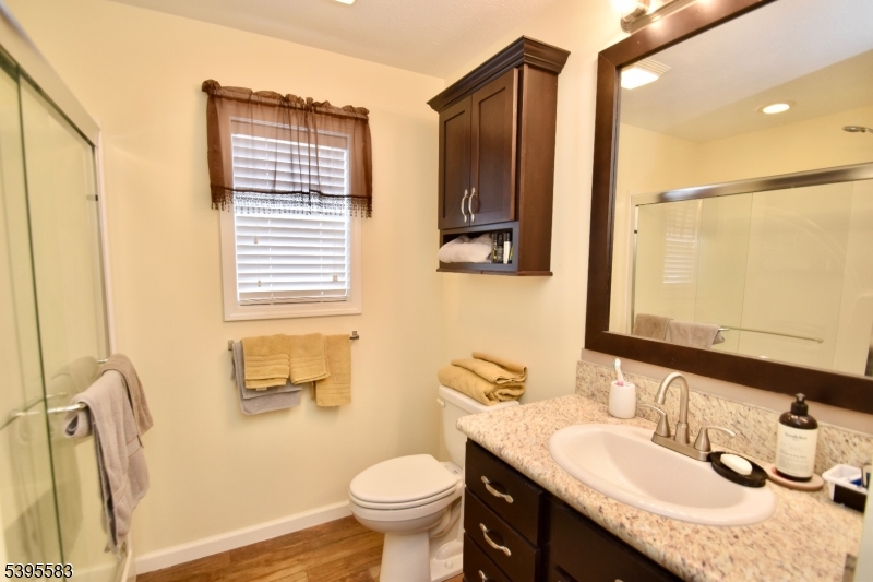 18 Easy Drive Oak Ridge, NJ 07438 - Photo 11 of 15 a bathroom with a granite countertop sink toilet and shower