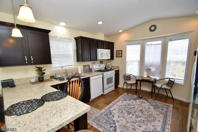 a kitchen with a stove a sink and a refrigerator