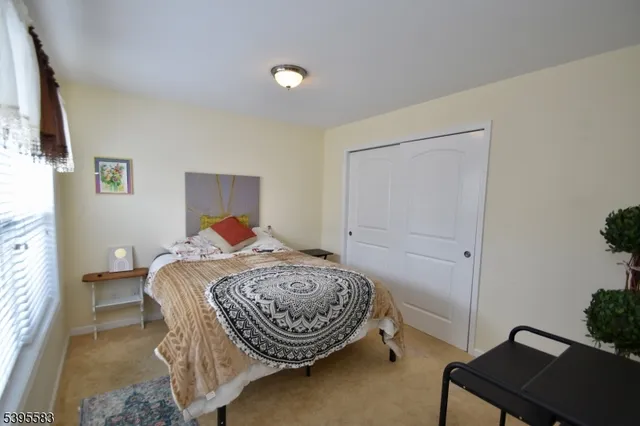 a bedroom with a bed and a potted plant
