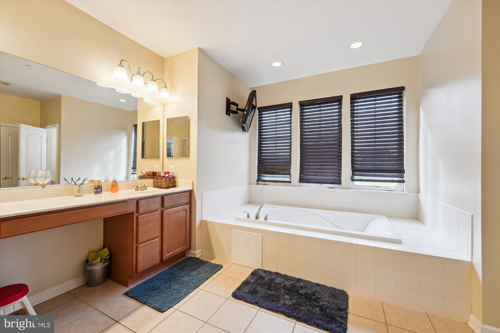 7306 Sudley Avenue Brandywine, MD 20613 - Photo 11 of 46 a spacious bathroom with a tub double sink and a mirror