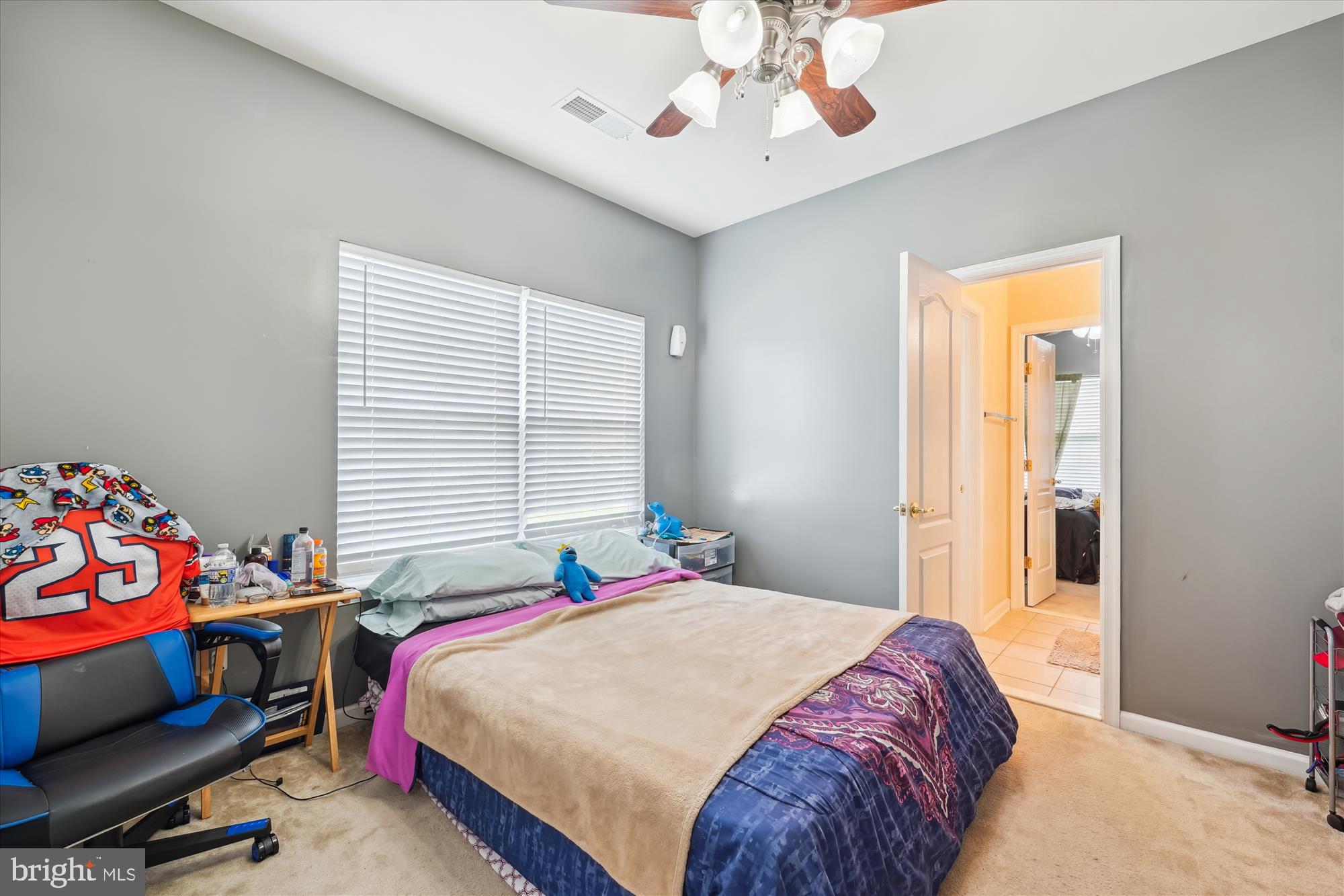 7306 Sudley Avenue Brandywine, MD 20613 - Photo 16 of 46 a bedroom with a bed and a chandelier