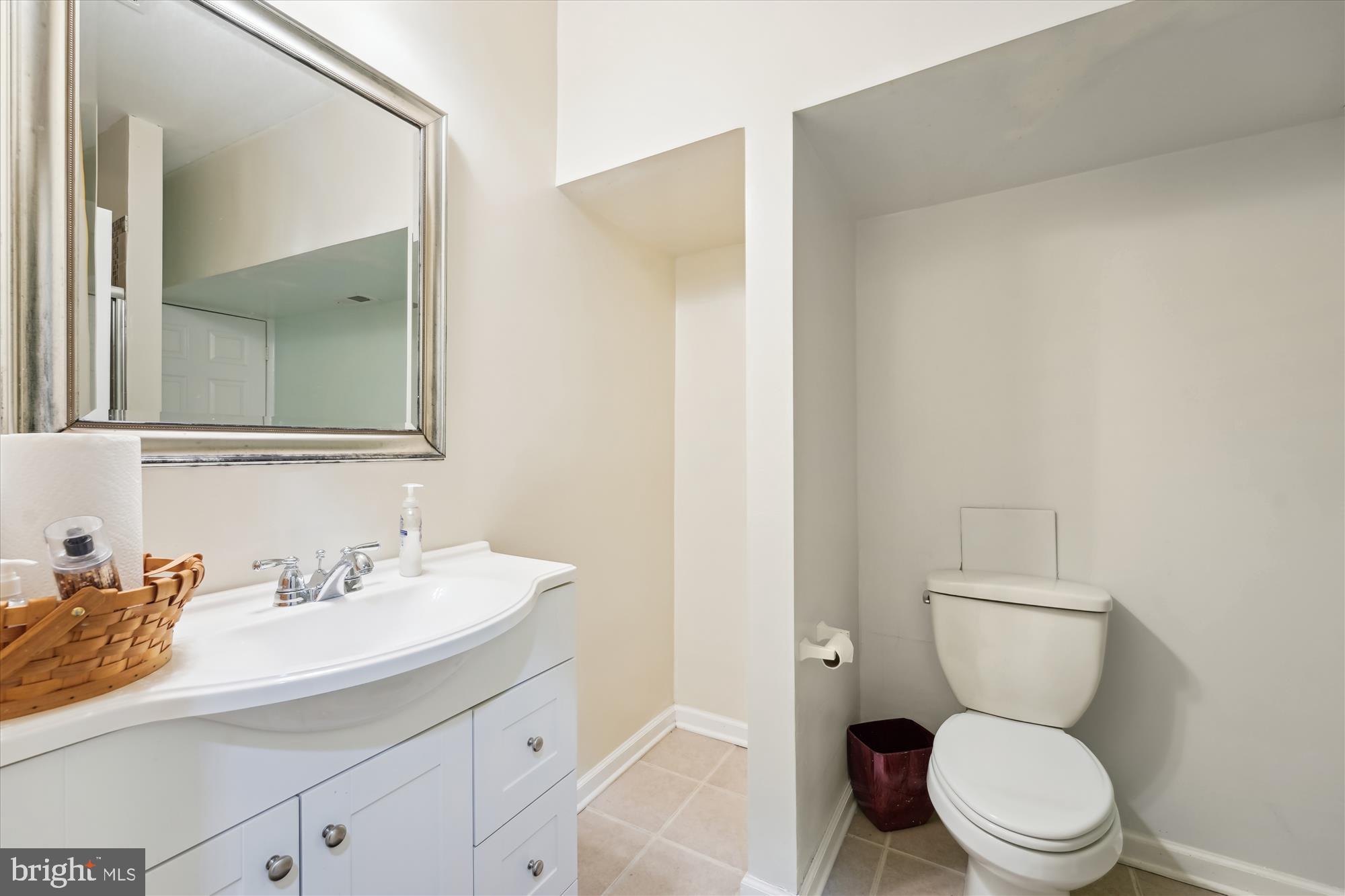 7306 Sudley Avenue Brandywine, MD 20613 - Photo 27 of 46 a bathroom with a toilet a sink and a mirror