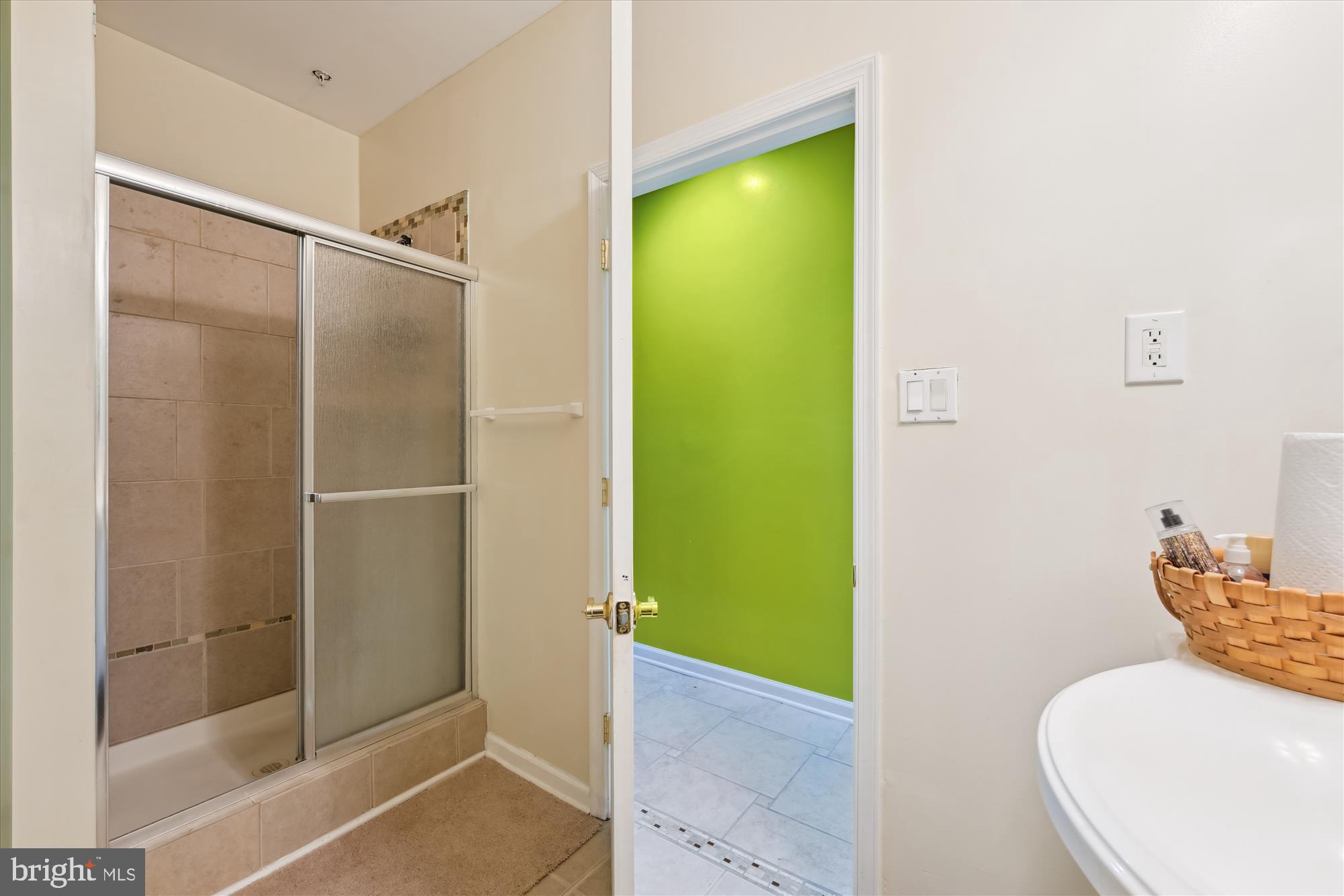 7306 Sudley Avenue Brandywine, MD 20613 - Photo 28 of 46 a bathroom with a granite countertop shower and a toilet