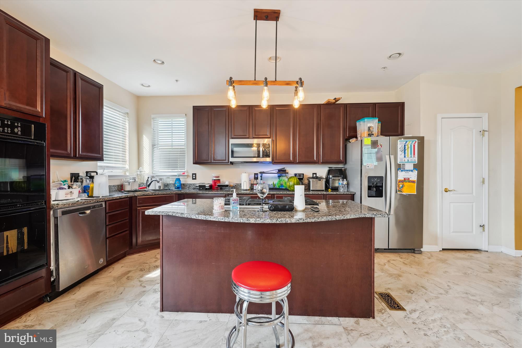 7306 Sudley Avenue Brandywine, MD 20613 - Photo 3 of 46 a kitchen with stainless steel appliances granite countertop a stove refrigerator and a microwave