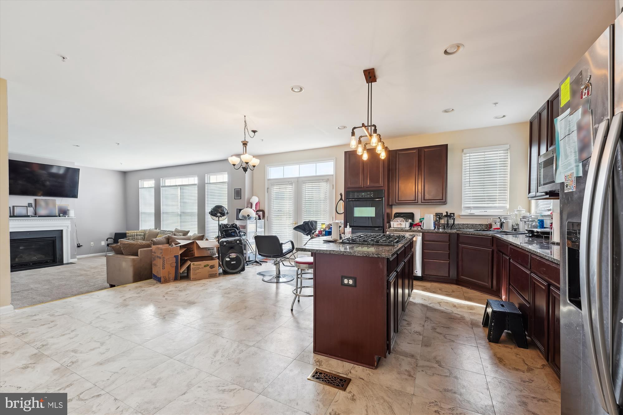 7306 Sudley Avenue Brandywine, MD 20613 - Photo 4 of 46 a large kitchen with sink a refrigerator and chairs