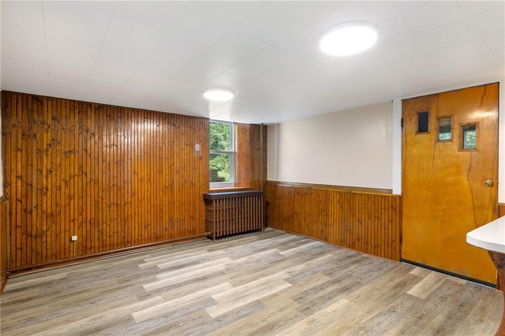 223 Thompson Run Road Pittsburgh, PA 15237 - Photo 6 of 23 a view of an empty room with wooden floor and a window