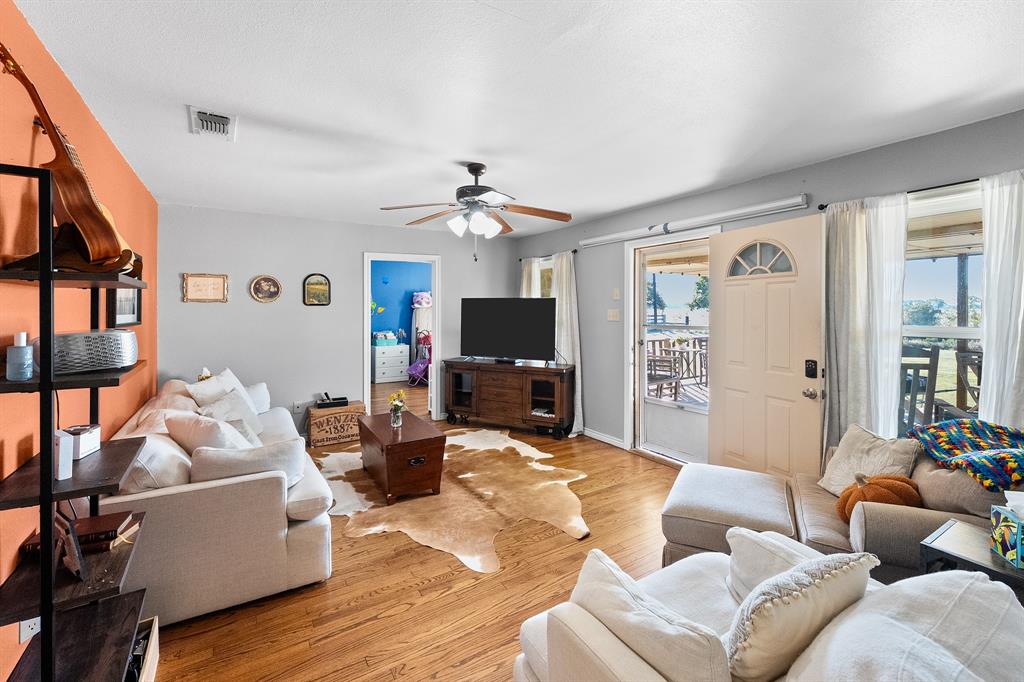 17215 Tarlton Road Mabank, TX 75147 - Photo 17 of 34 a living room with furniture and a flat screen tv