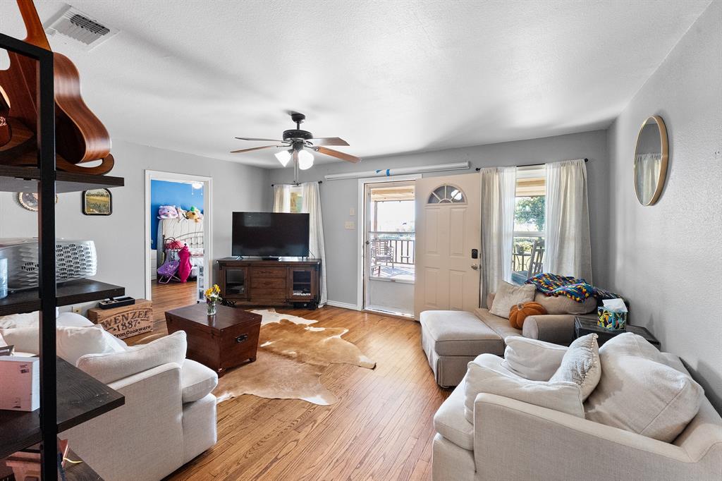 17215 Tarlton Road Mabank, TX 75147 - Photo 18 of 34 a living room with furniture and a flat screen tv
