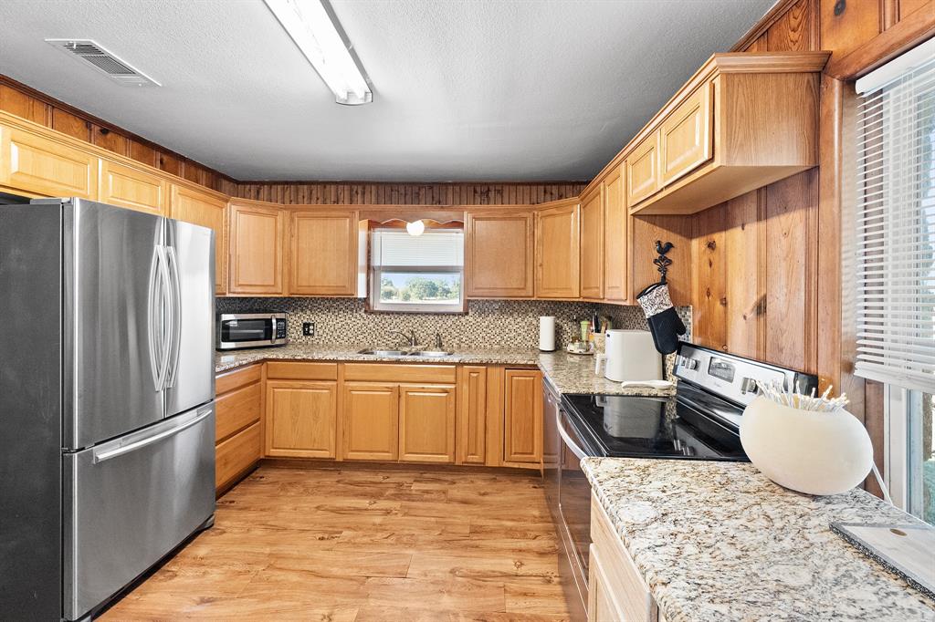 17215 Tarlton Road Mabank, TX 75147 - Photo 19 of 34 a kitchen with stainless steel appliances granite countertop a refrigerator sink and cabinets
