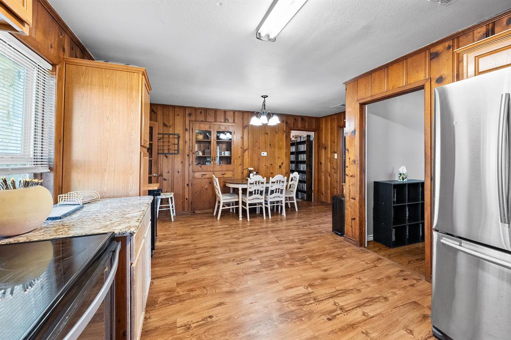 17215 Tarlton Road Mabank, TX 75147 - Photo 24 of 34 a kitchen with stainless steel appliances granite countertop a refrigerator table and chairs