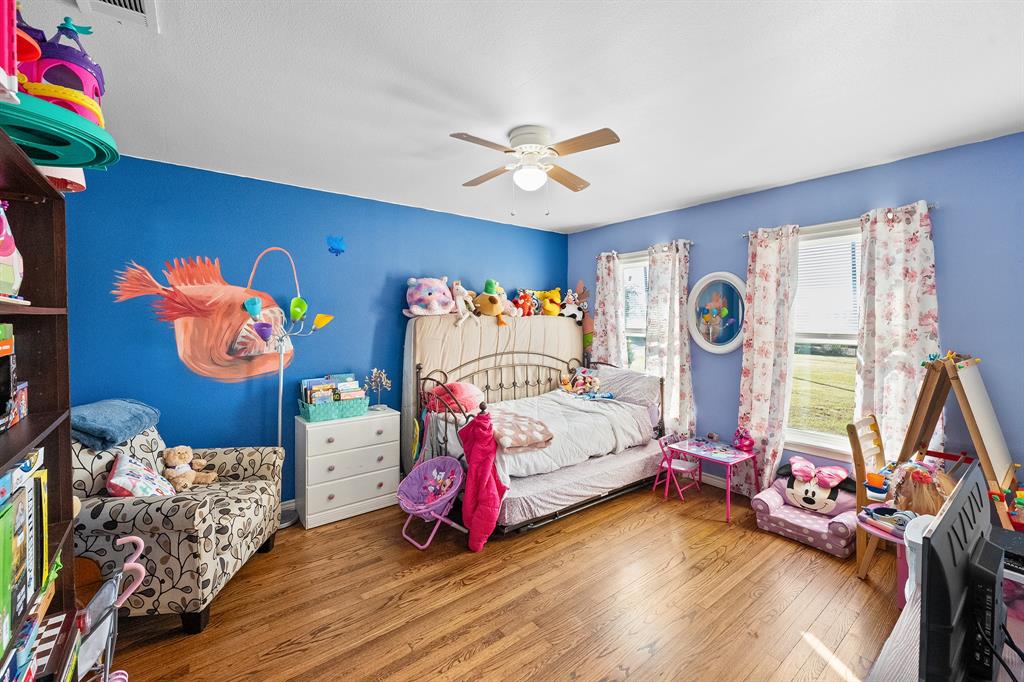 17215 Tarlton Road Mabank, TX 75147 - Photo 26 of 34 a bedroom with baby bed a window and dresser