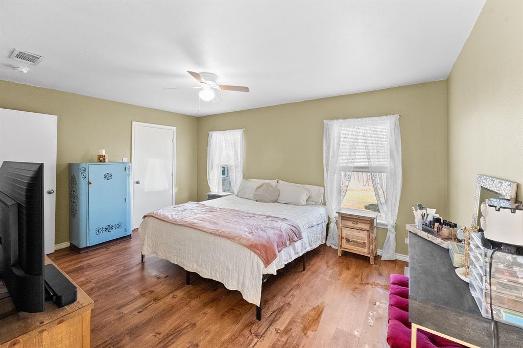 17215 Tarlton Road Mabank, TX 75147 - Photo 29 of 34 a bedroom with a bed and wooden floor