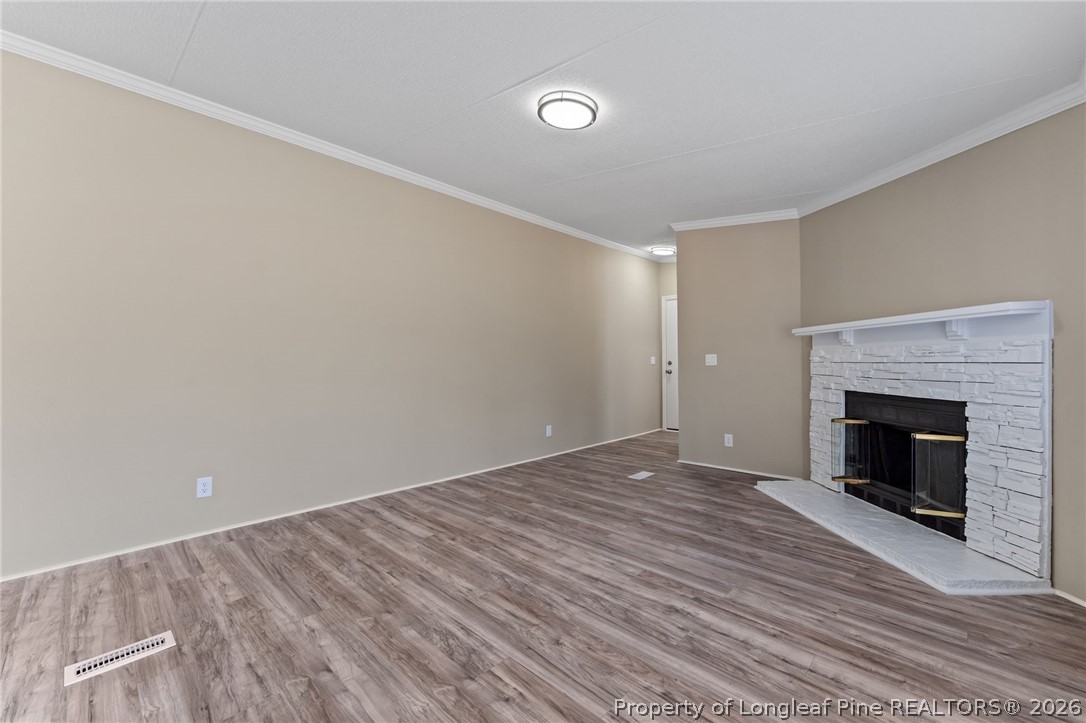 515 Mt Zion Road Red Springs, NC 28377 - Photo 4 of 50 a view of empty room with wooden floor and fireplace