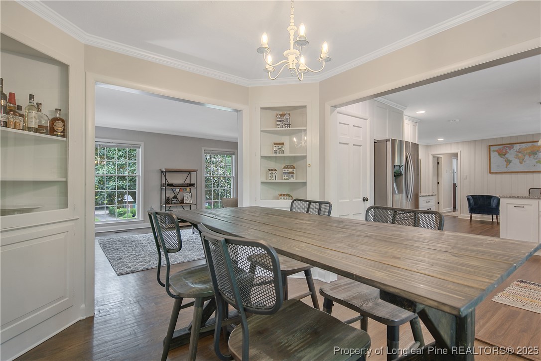 2615 Huntington Road Fayetteville, NC 28303 - Photo 14 of 47 a view of a dining room with furniture and wooden floor