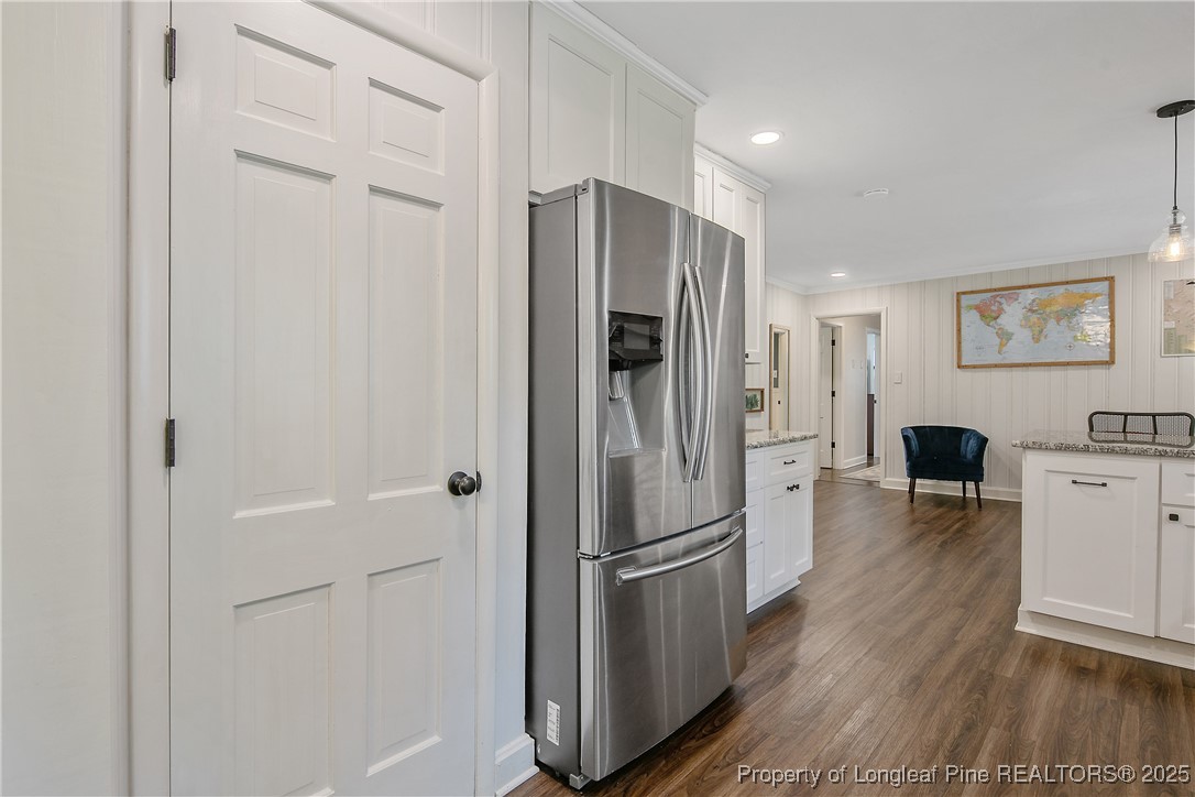 2615 Huntington Road Fayetteville, NC 28303 - Photo 15 of 47 a kitchen with stainless steel appliances a refrigerator and wooden floor