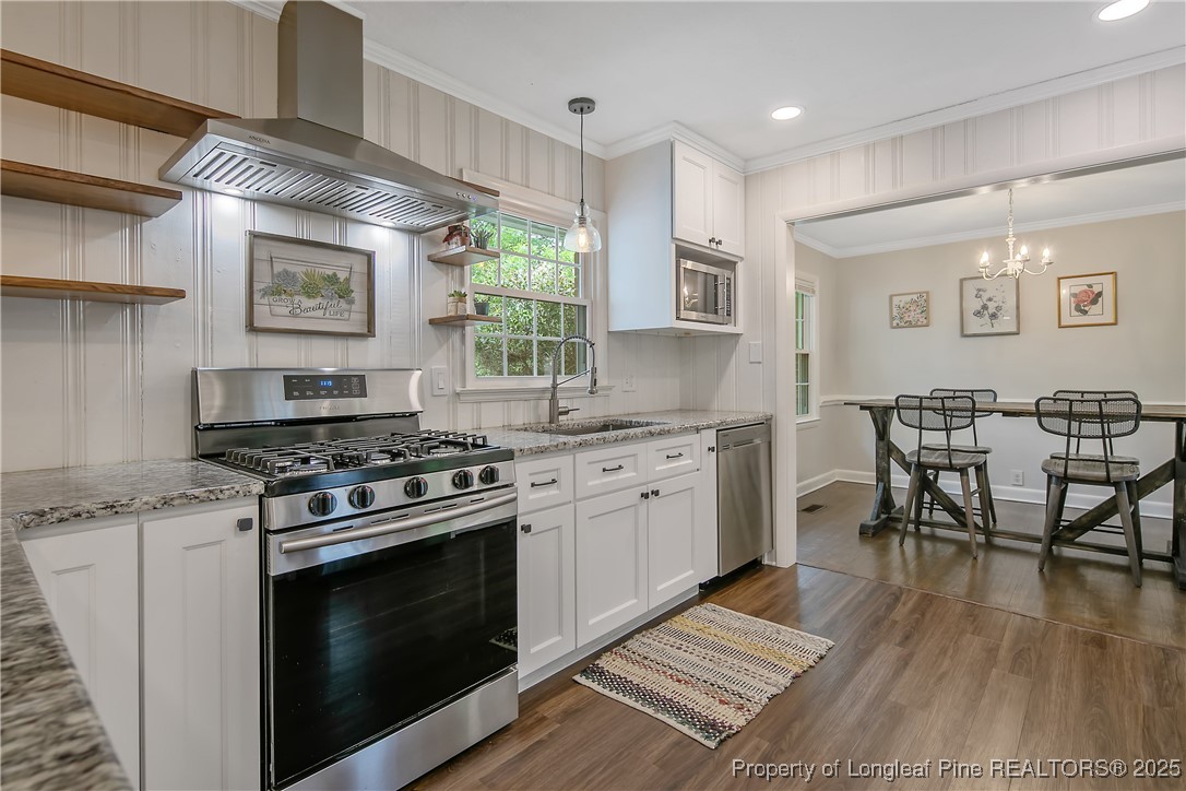 2615 Huntington Road Fayetteville, NC 28303 - Photo 18 of 47 a kitchen with stainless steel appliances a stove a sink dishwasher and a refrigerator