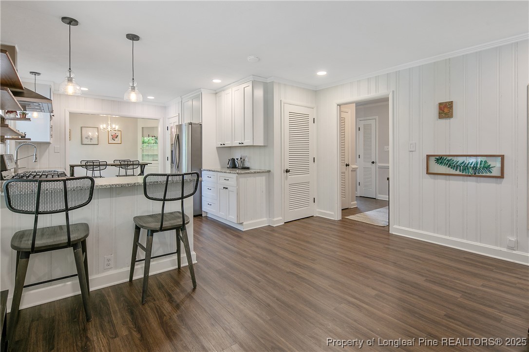 2615 Huntington Road Fayetteville, NC 28303 - Photo 26 of 47 an empty room with wooden floor and windows