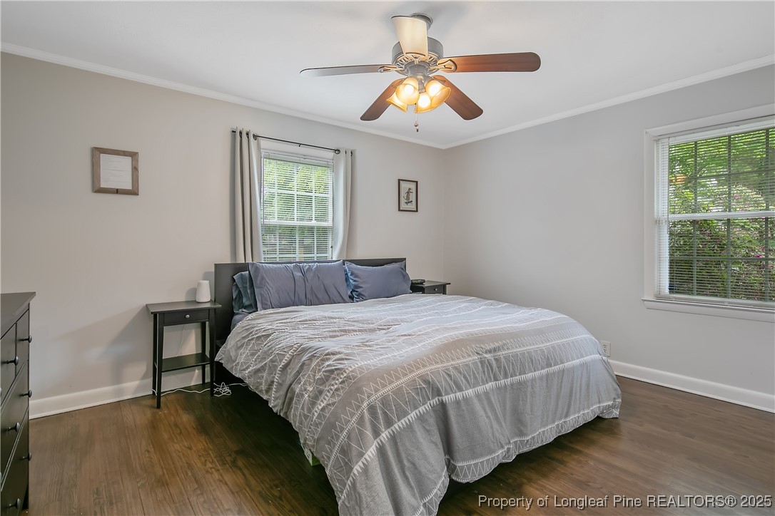 2615 Huntington Road Fayetteville, NC 28303 - Photo 28 of 47 a bedroom with a bed and a chandelier