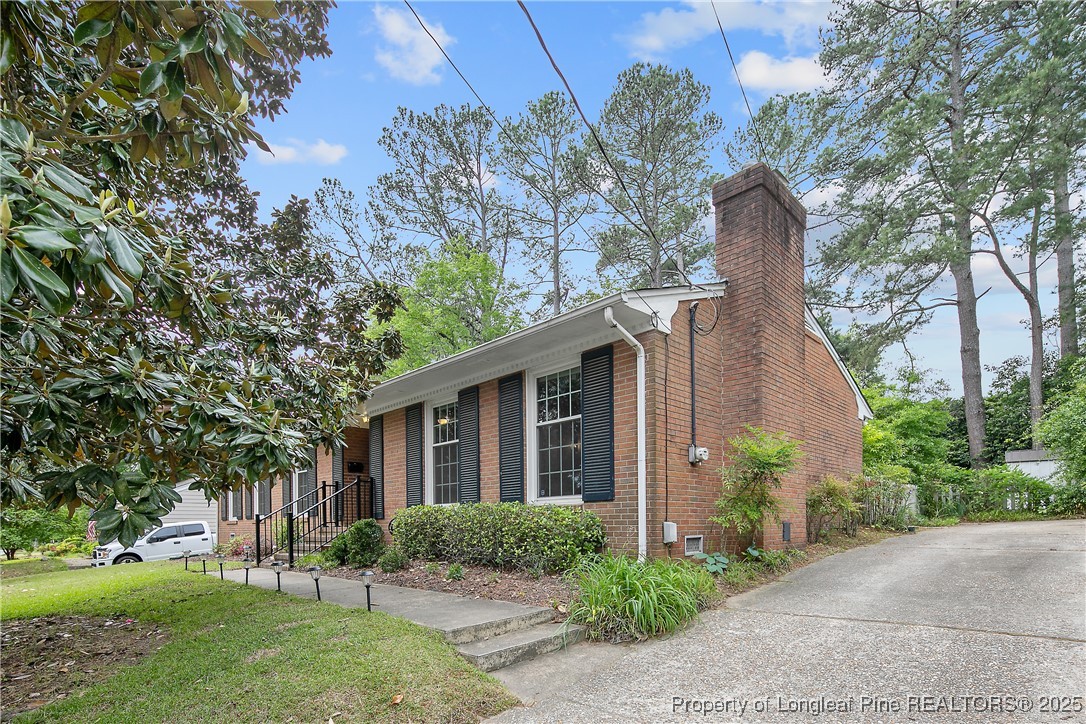2615 Huntington Road Fayetteville, NC 28303 - Photo 3 of 47 a front view of a house with garden