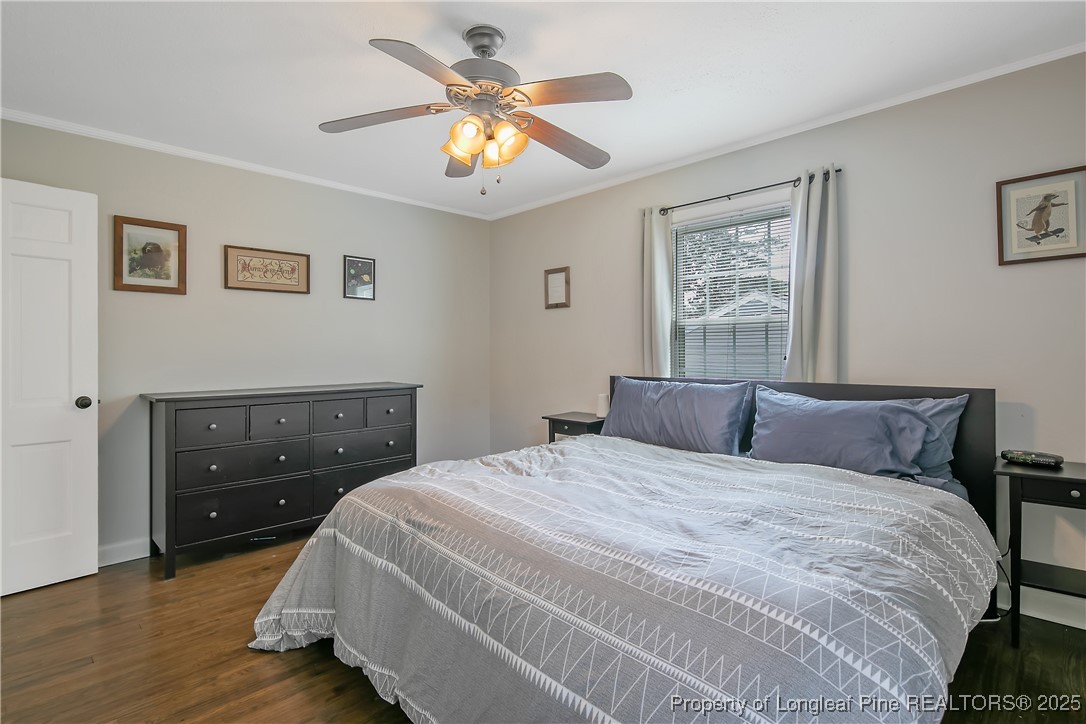 2615 Huntington Road Fayetteville, NC 28303 - Photo 31 of 47 a bedroom with a bed and a chandelier