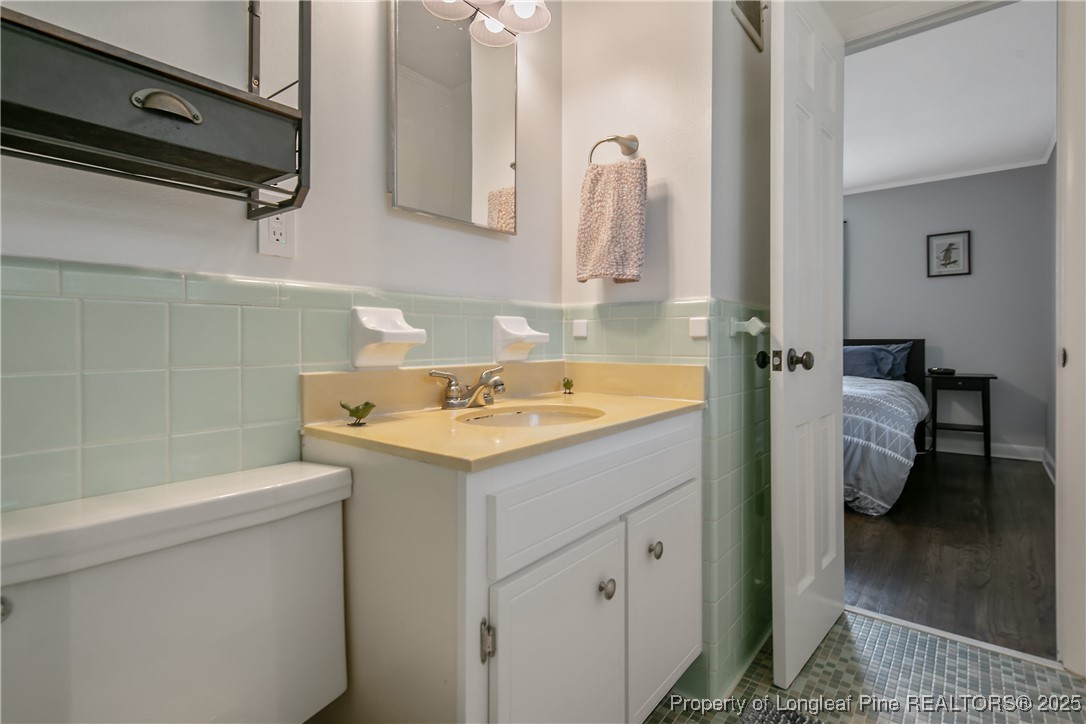 2615 Huntington Road Fayetteville, NC 28303 - Photo 33 of 47 a bathroom with a sink and a mirror