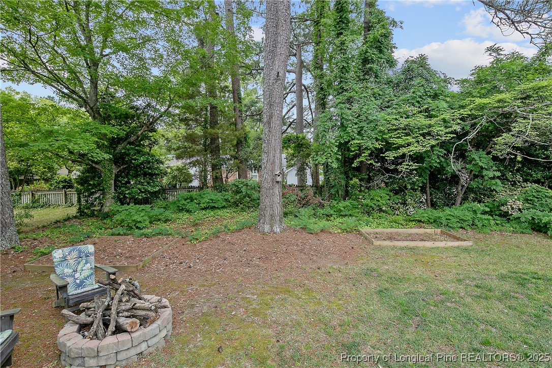 2615 Huntington Road Fayetteville, NC 28303 - Photo 45 of 47 a view of a patio with table and chairs plants and trees