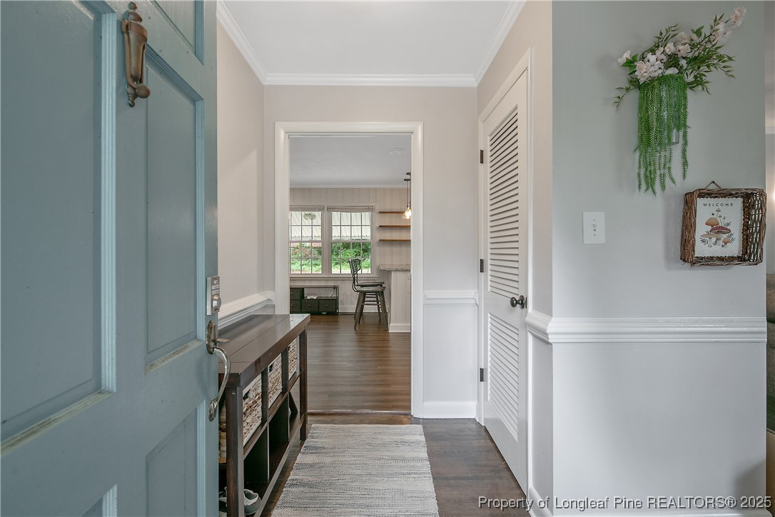 2615 Huntington Road Fayetteville, NC 28303 - Photo 5 of 47 a hallway with a dining table and a chairs