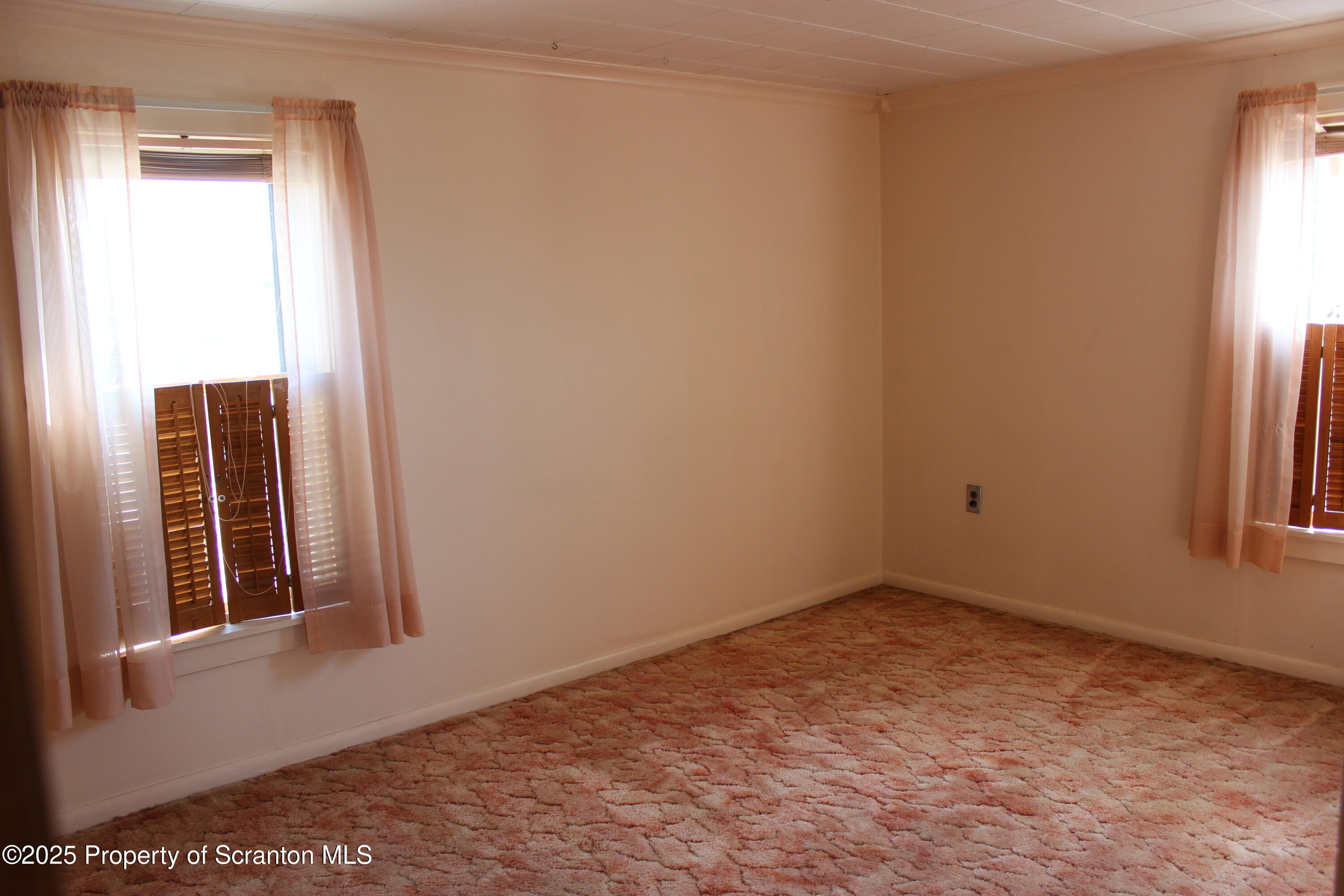 1010 McAlpine Street Avoca, PA 18641 - Photo 17 of 22 a view of an empty room with a window