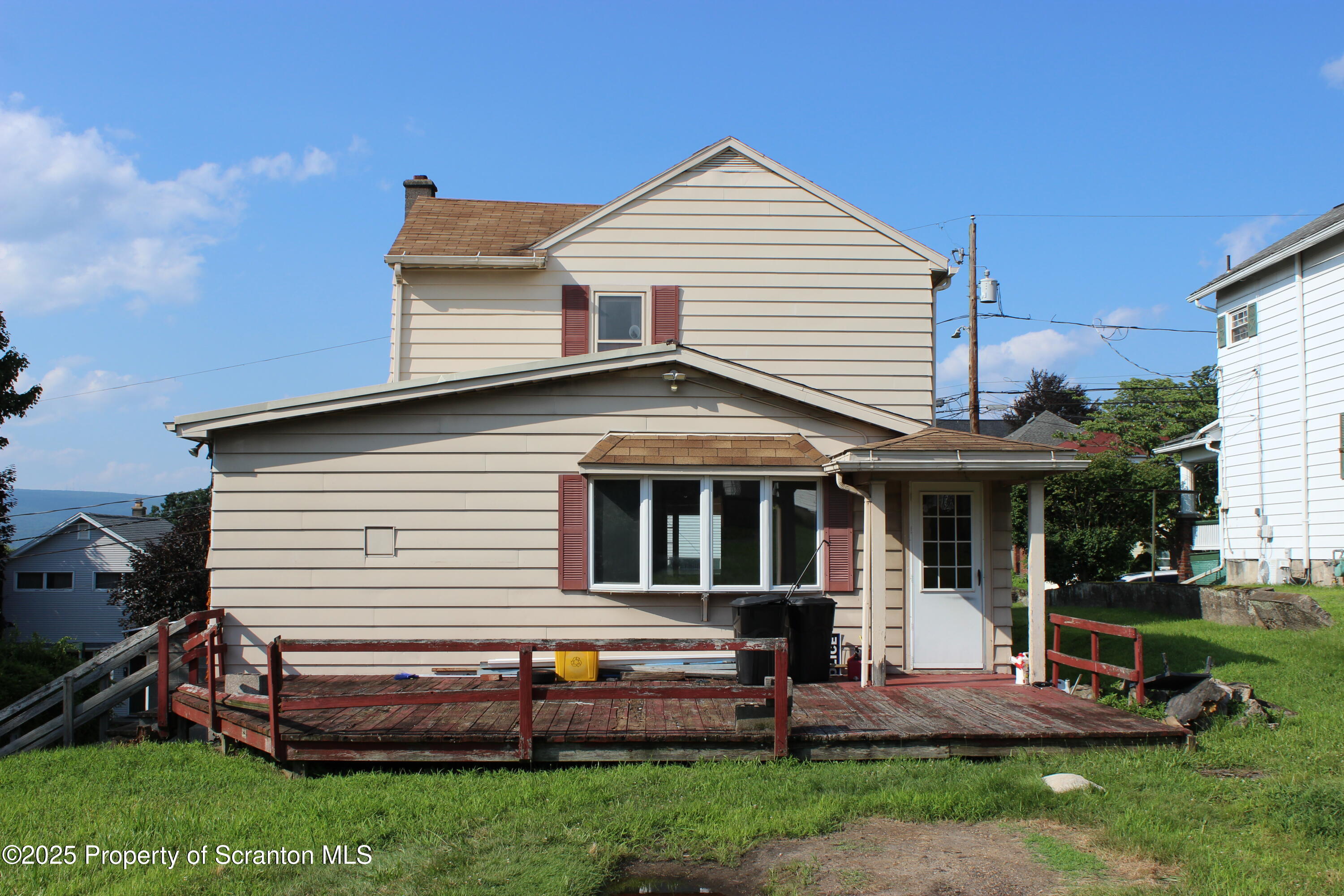 1010 McAlpine Street Avoca, PA 18641 - Photo 2 of 22 a front view of a house with a yard table and chairs
