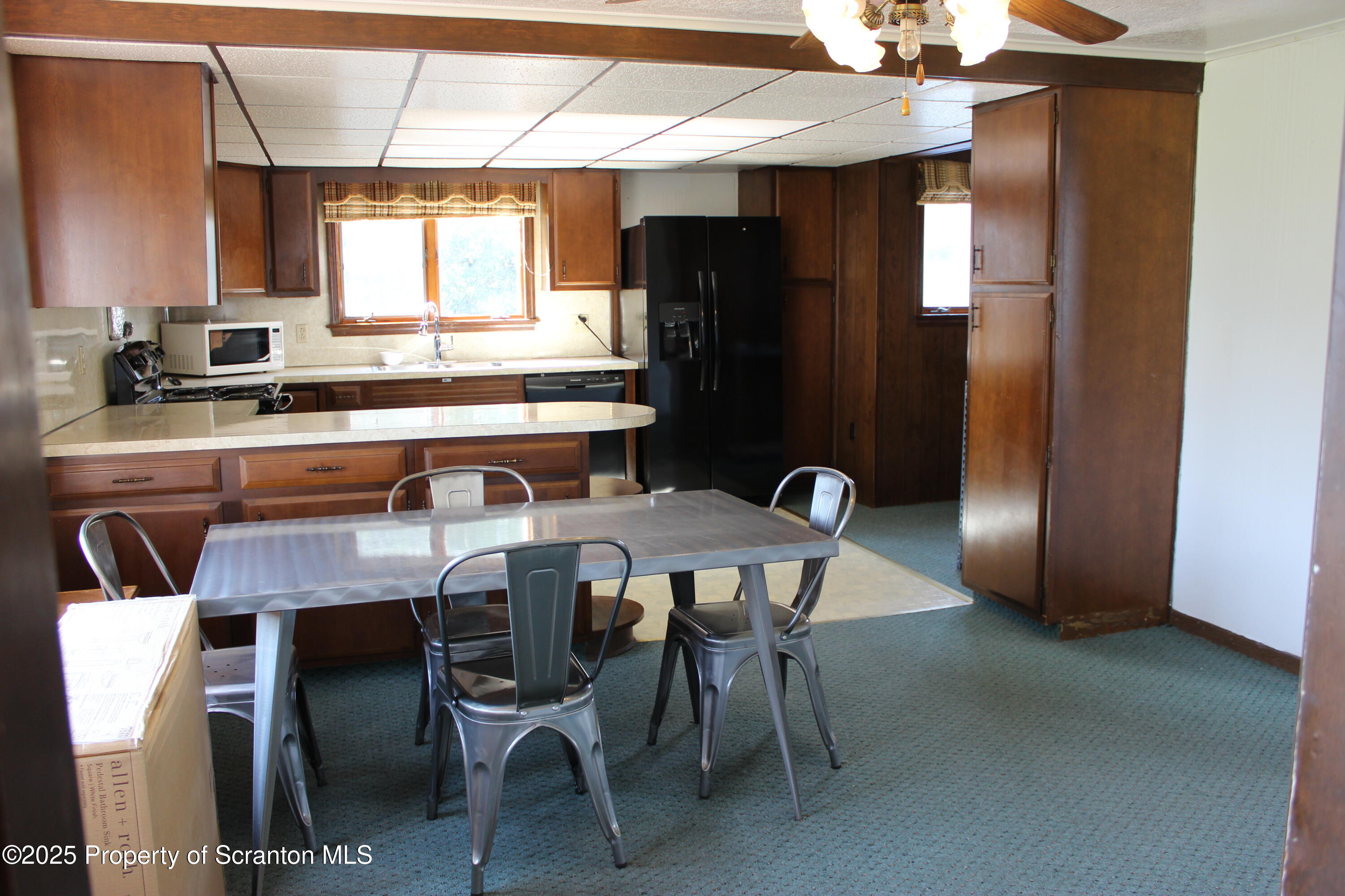 1010 McAlpine Street Avoca, PA 18641 - Photo 10 of 22 a table and chairs in a kitchen