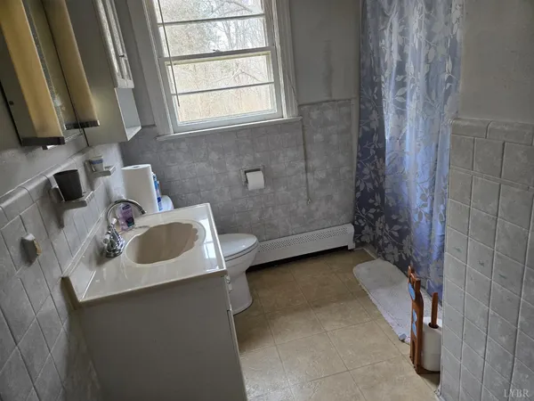 a bathroom with a shower and a sink