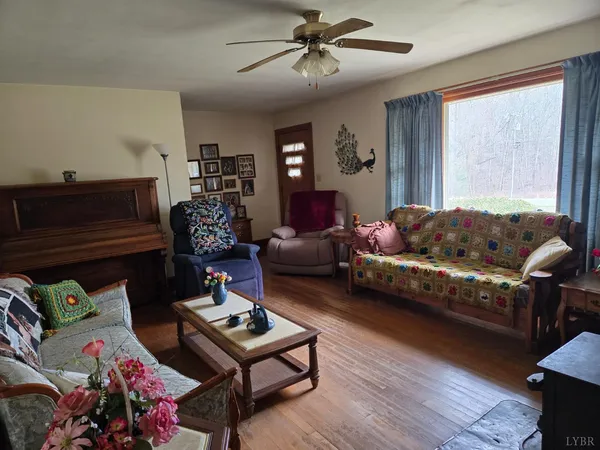 a living room with furniture a rug and a window