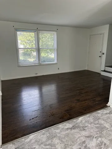 a view of wooden floor and windows in a room