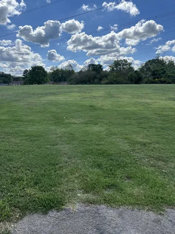 a view of a field with an ocean and covered