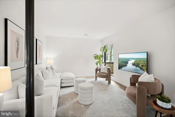 a living room with furniture a couch and a flat screen tv