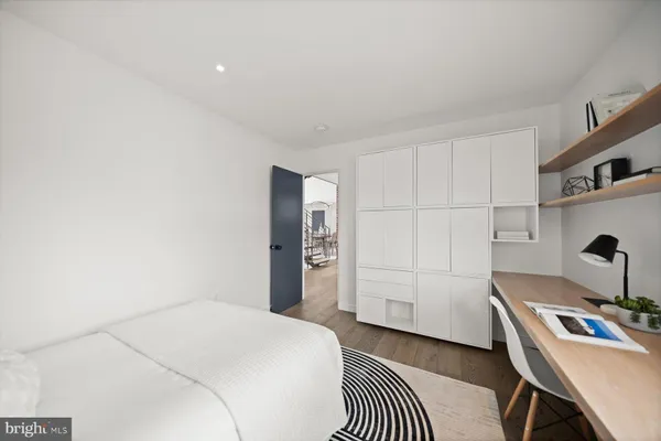 a bedroom with a bed and a night stand