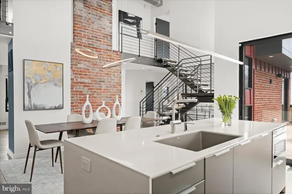 a kitchen with stainless steel appliances granite countertop a sink and a stove