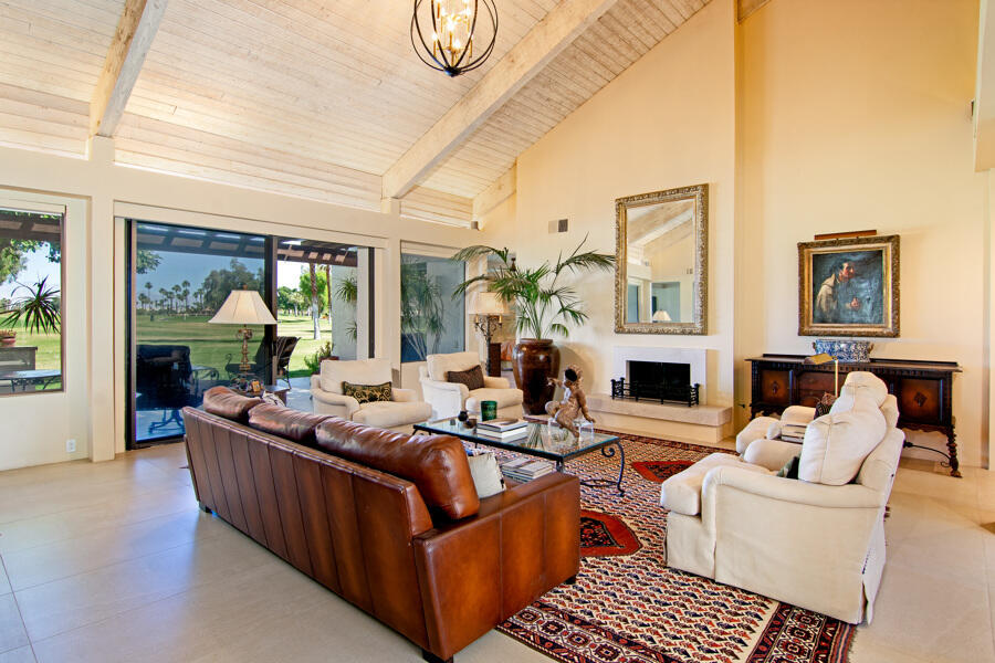 723 Inverness Drive Rancho Mirage, CA 92270 - Photo 2 of 49 a living room with fireplace furniture and a large window
