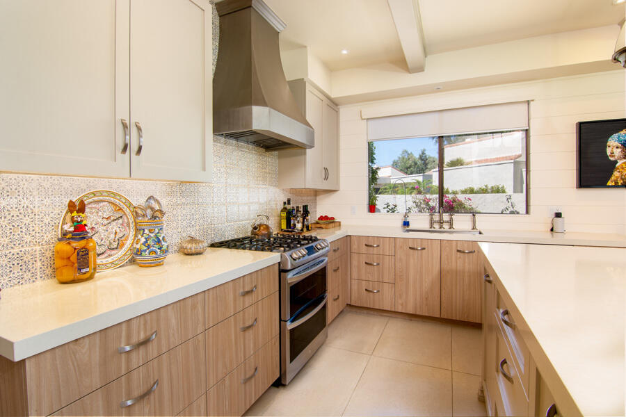 723 Inverness Drive Rancho Mirage, CA 92270 - Photo 11 of 49 a kitchen with a sink a stove and cabinets