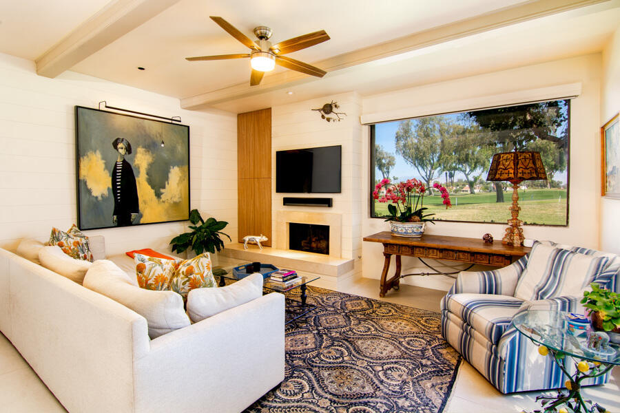 723 Inverness Drive Rancho Mirage, CA 92270 - Photo 12 of 49 a living room with furniture a flat screen tv and a floor to ceiling window