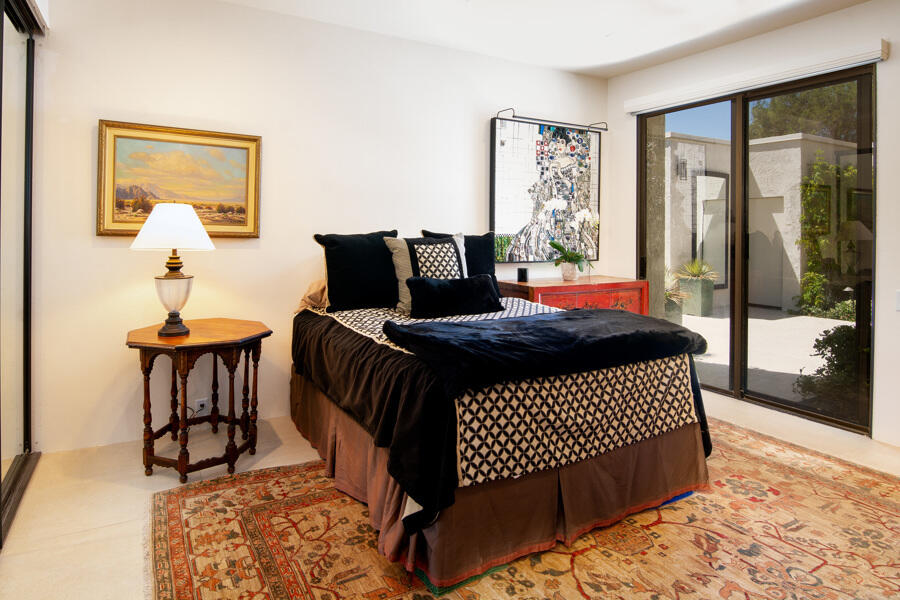 723 Inverness Drive Rancho Mirage, CA 92270 - Photo 18 of 49 a bedroom with a bed and wooden floor